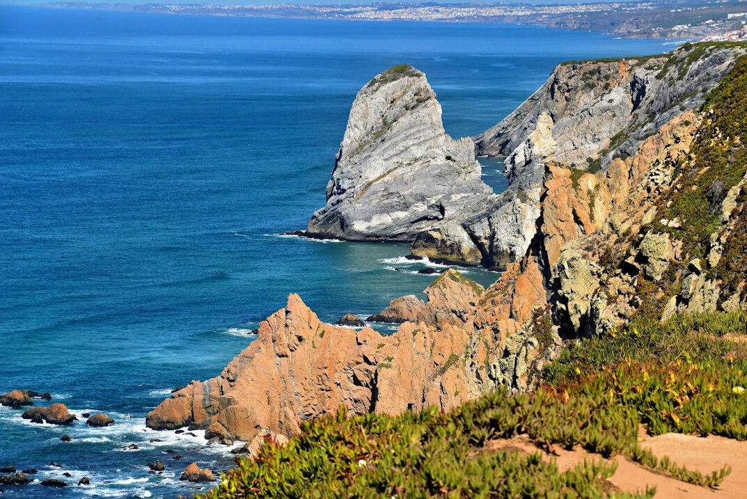 Aerial view of a rugged Portuguese coastline with cliffs and ocean